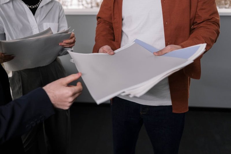 Singapore business owner comparing two SEO agency proposals side-by-side on a laptop screen